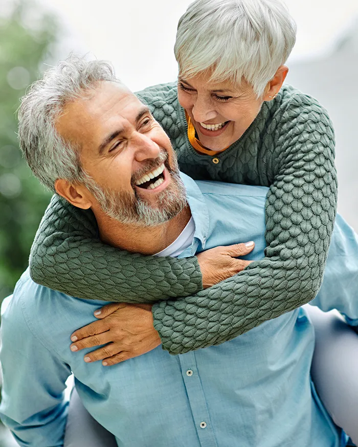 Older Smiling Couple After Dentures Procedure