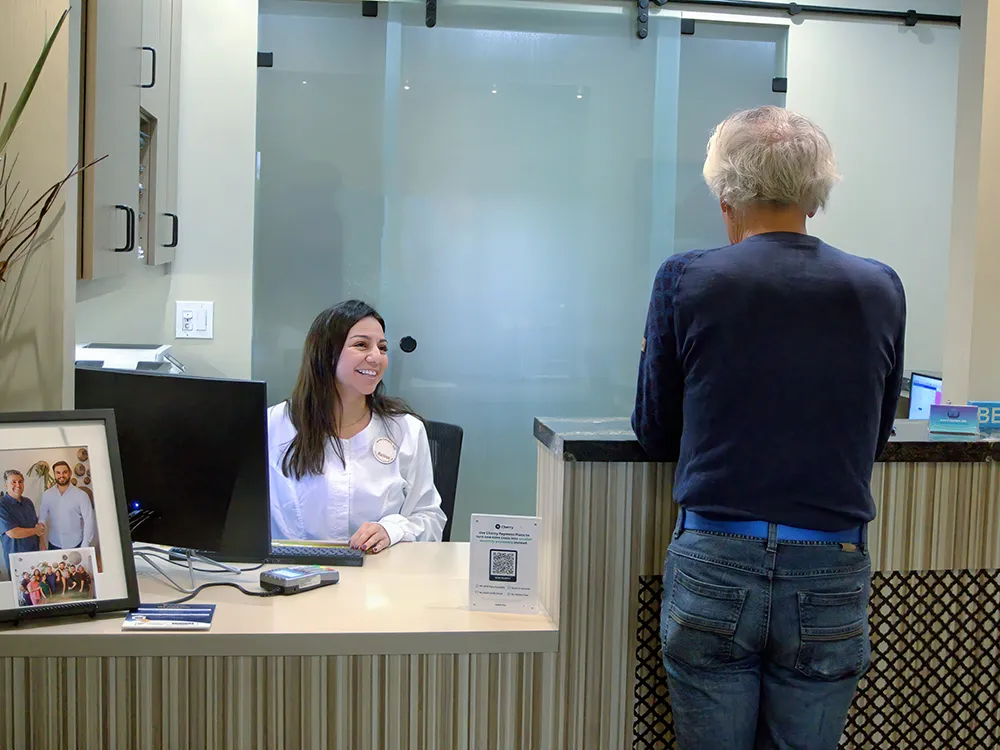 Office Manager Assisting A Patient